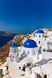 Santorinis iconic blue domes and white architecture overlooking