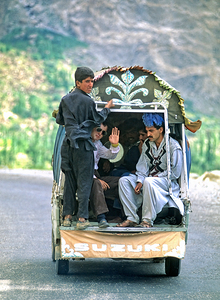 People traveling in a Suzuki on the road to Chitral in Pakistan