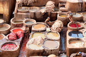 Workers dye leather at Chouara Tannery in Fez Morocco