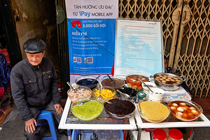 Street vendor selling desserts in Hanoi Vietnam at market by Marco Brivio