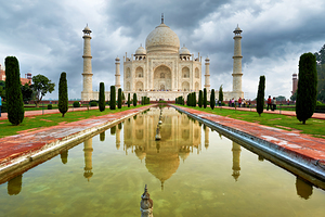 Visitors explore the Taj Mahal Palace in cloudy Agra