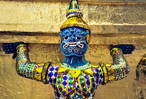 Statue at Wat Phra Kaew in Bangkok holds up structure