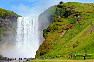 People visiting Skogafoss waterfall during daylight in Iceland