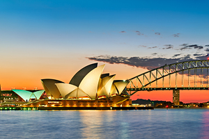 Sydney Opera House and Harbour Bridge at sunset.