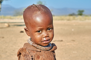 Portrait of a child from Himba village in Kunene region of Namib