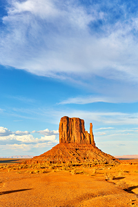 Monument Valley shows red rock formations under blue sky