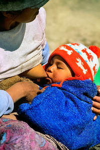 Indigenous mother nourishes child in the Andes of Argentina