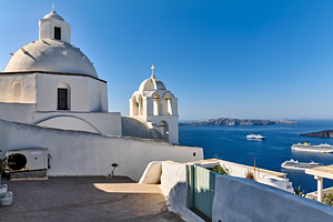 Santorini: White churches blue sea and cruise ships.