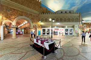 Indoor mall in Dubai features shops and a dining setup with peop