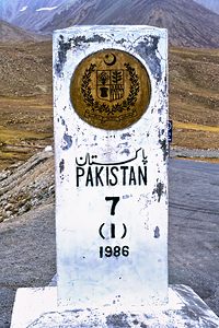Distance marker showing 7 kilometers to Pakistan on road in 1986