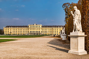 Schönbrunn Palace Vienna with statues and autumn trees.