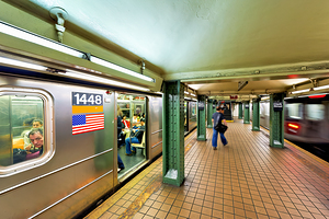 People wait at Manhattan subway station in New York City