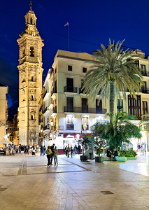 Santa Catalina Church in Valencia Spain at night with people wal
