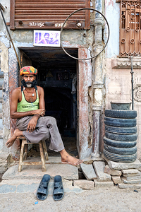 Man sitting outside a shop in Bikaner Rajasthan during the day
