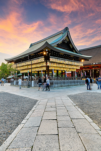 Yasaka shrine temple in Kyoto with visitors at sunset