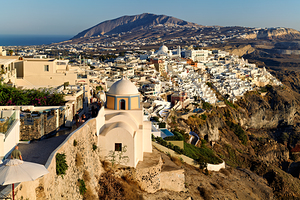 Santorini cliffside town with white buildings overlooking the Ae