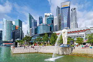 People walk in Singapores financial district near the bridge