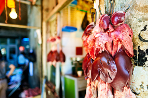 Butcher displays meat at souq in Aleppo Syria during the day