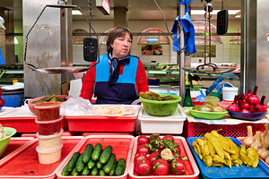 Vendor sells fresh produce at Kuznechnyy Rynok St. Pete
