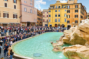 Crowd of tourists visiting Trevi Fountain in Rome during the day