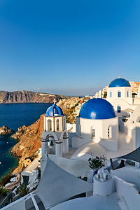 Beautiful Santorini: White buildings blue domes and sea views.