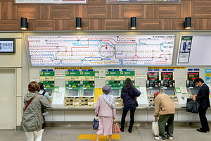 Metro ticket purchase at machine in Tokyo station during daytime