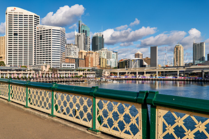 Sydney Harbour skyline with modern buildings and water.