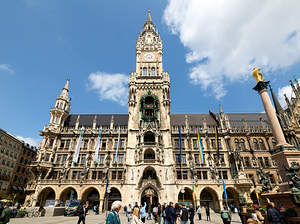 Tourists explore Munichs town hall in Marienplatz on a sunny da