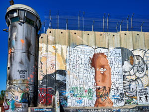 Wall and artwork near a guard tower in Bethlehem Jerusalem