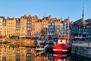 Sunrise at Honfleur harbour in Normandy France with reflections