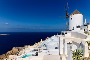 Santorinis iconic white architecture and windmill against the d