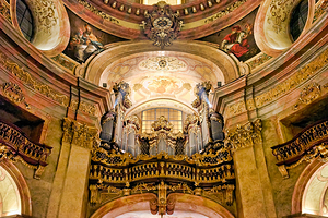 Grand baroque church interior featuring ornate organ frescoes 