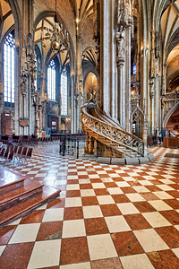 Ornate Gothic cathedral interior with checkered floor and spiral