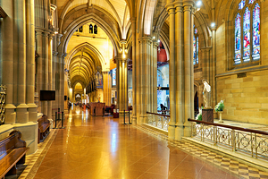 Interior of a grand cathedral with stained glass windows.