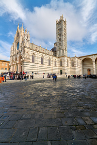 Siena Cathedral in Tuscany Italy with visitors in daylight