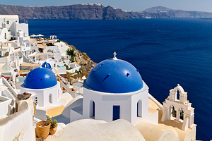 Beautiful Santorini: White buildings blue domes and deep blue 