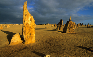Pinnacles desert landscape at sunset with dramatic clouds.