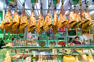 Central Market in Valencia showcases meat display and vendor act