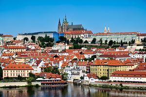 Prague Castle and city skyline over Vltava River.