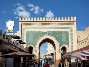 People walk through Bab Bou Jeloud a famous gate in Fez Morocc