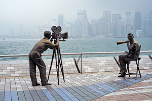 Bronze film crew statues stand on Hong Kong waterfront by the se by Marco Brivio