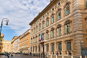 Palazzo Madama in Rome along a city street with people and vehic