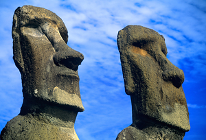 Two Moai statues against a blue sky.