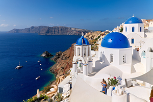 Picturesque Santorini: blue domes white buildings and caldera 