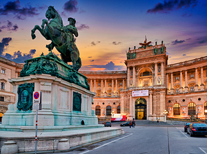 Viennas Hofburg Palace and equestrian statue at twilight.