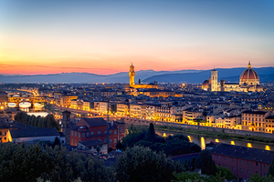 High view of Florence at dusk with city lights and landmarks