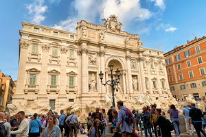 Crowd of tourists visiting Trevi Fountain in Rome Italy