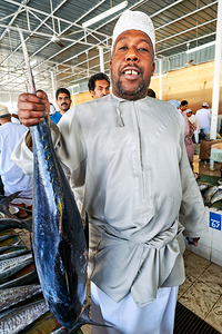 Fish seller shows catch in Muscat Oman fish market