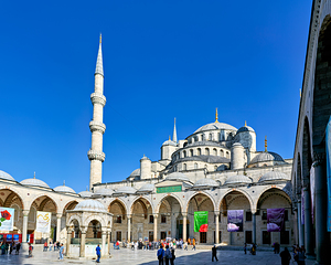 People walk around the Blue Mosque in Istanbul Turkey