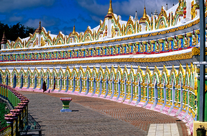 Visitors walk along the colorful walls at Sagaing Paya in Myanma by Marco Brivio